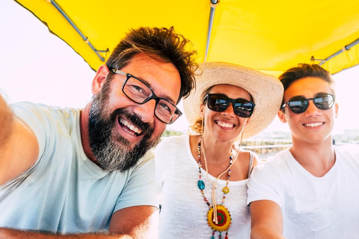 Cheerful friends enjoying a summer boat trip