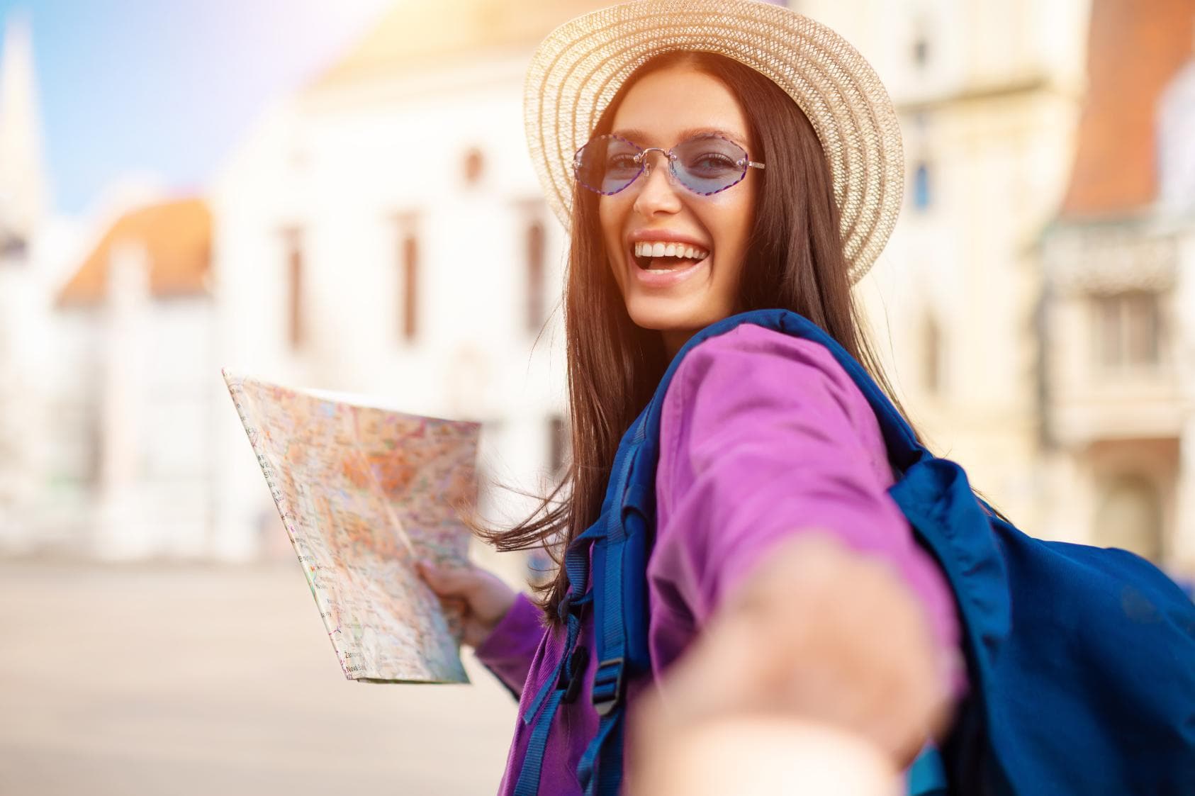 Happy tourist exploring with a map